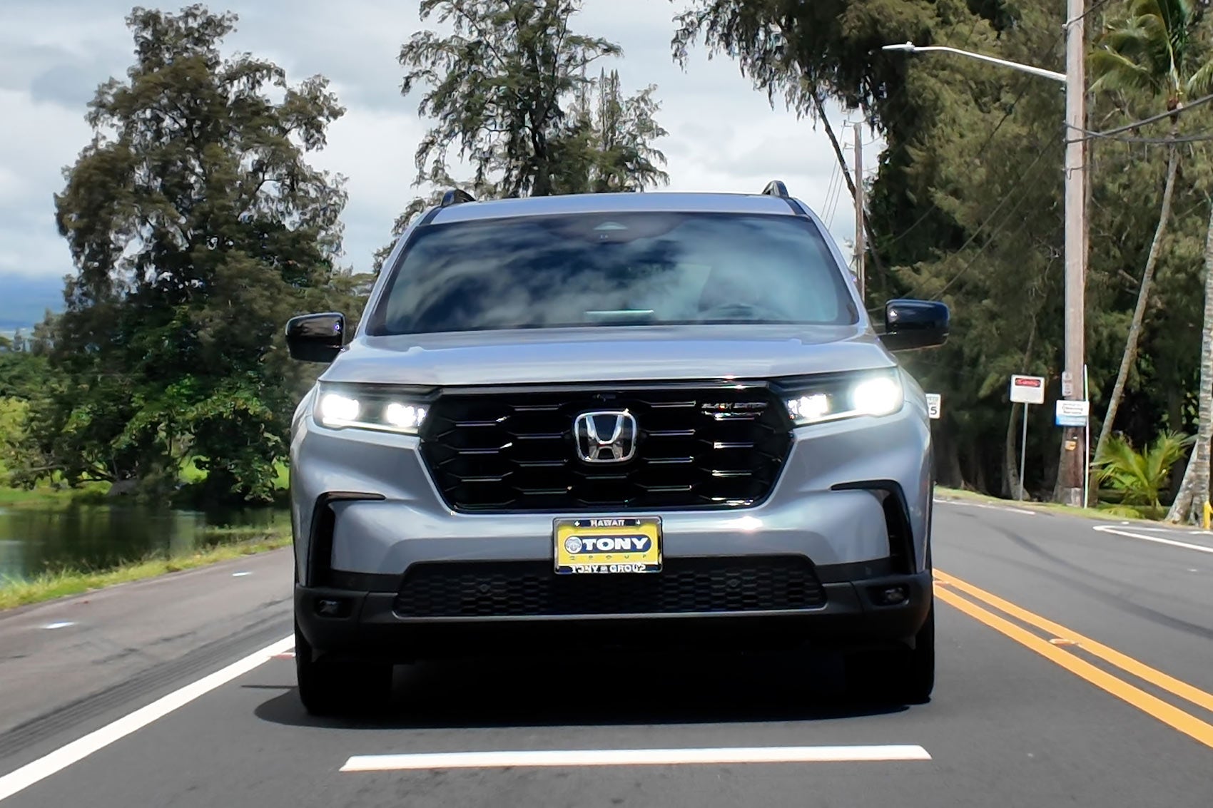 Car keys and fob with customer signing paperwork in the background
